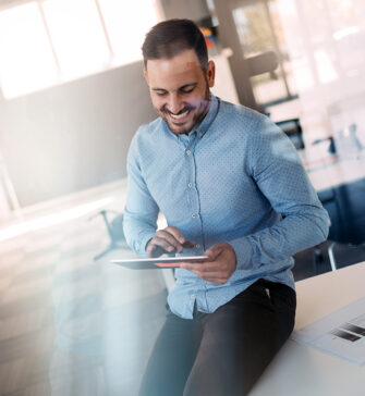 Portrait of a young successful manager using touch pad to prepare for working day Portrait of a young successful manager using touch pad to prepare for day